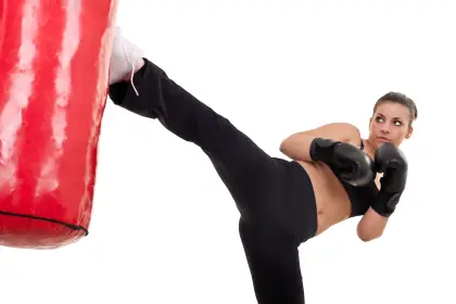 Woman Kicking Punching Bag