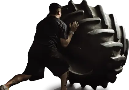 Man Pushing a Large Tire