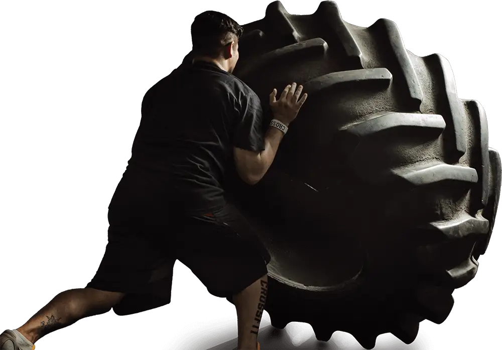 Man Pushing a Large Tire