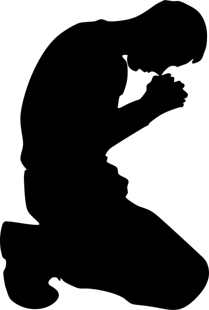 Silhouette of a Person Kneeling in Prayer