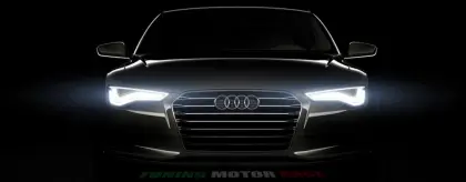 Front View of Audi Car with Headlights On
