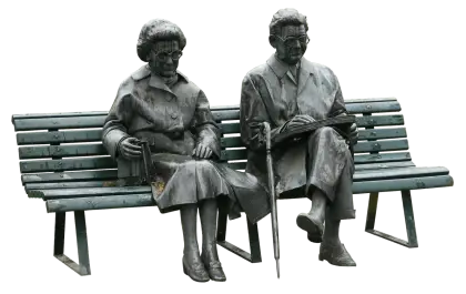 Statue of Two People Sitting on a Bench