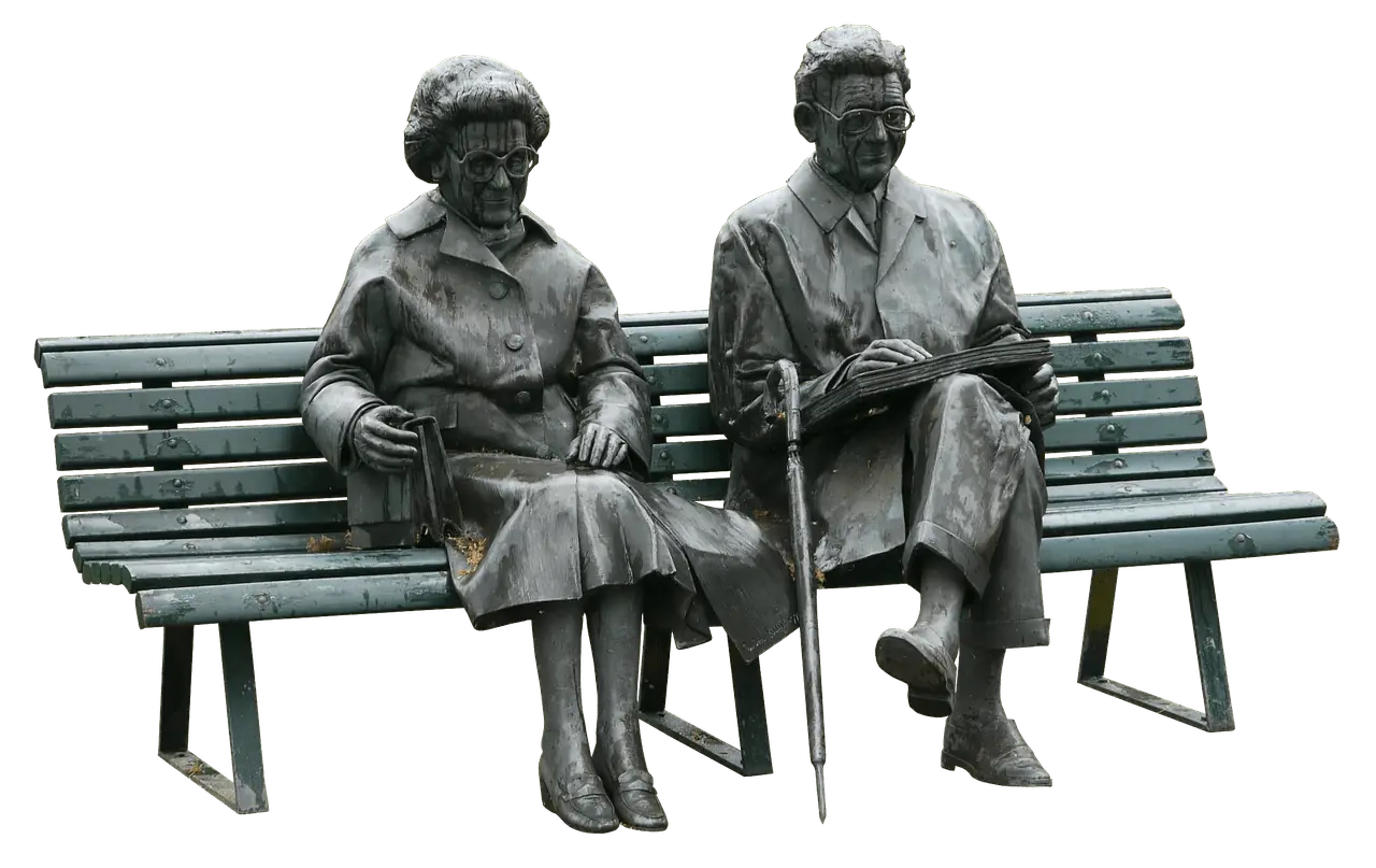 Statue of Two People Sitting on a Bench