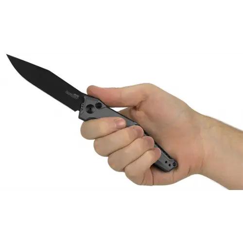 Hand Holding a Folding Knife with Black Blade