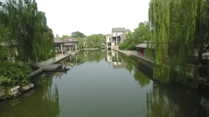 Tranquil Water Canal with Houses and Trees