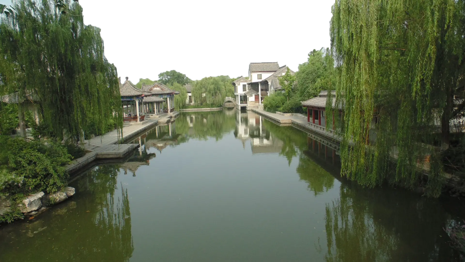 Tranquil Water Canal with Houses and Trees