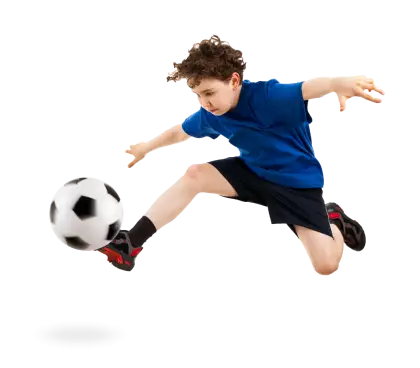 Young Soccer Player Kicking Ball