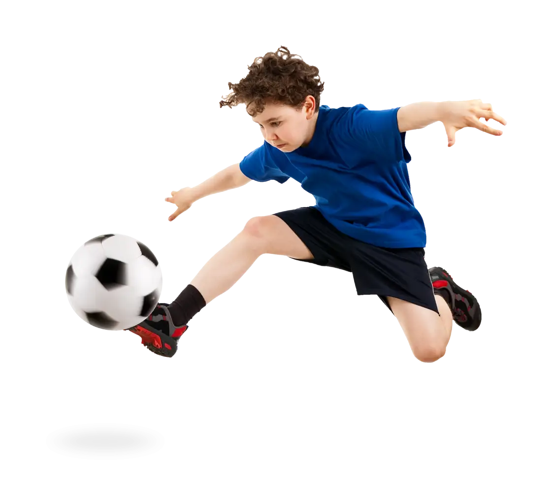 Young Soccer Player Kicking Ball
