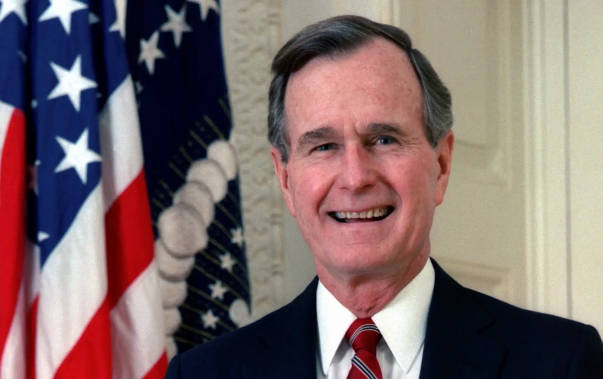 Smiling Man in Suit with American Flag
