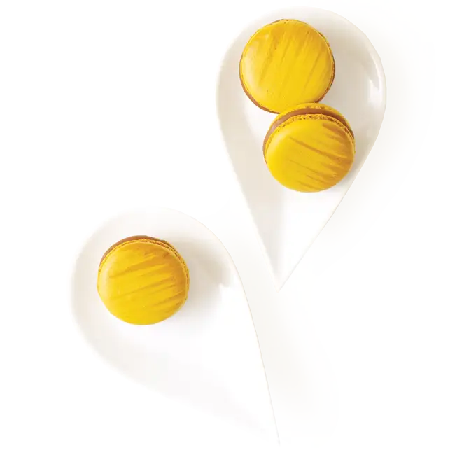 Yellow Macarons on White Plates