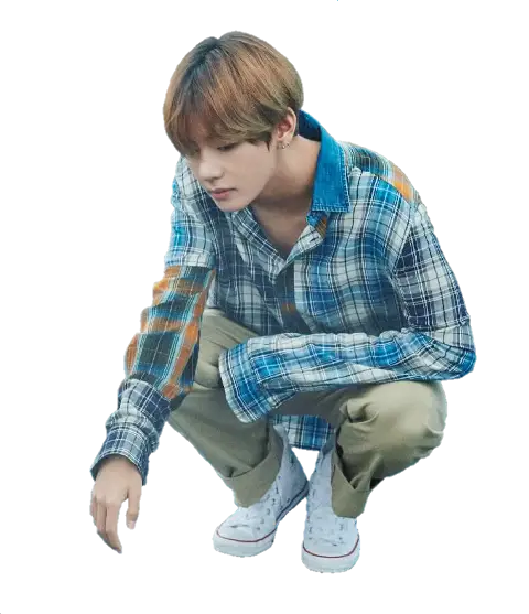 Individual Crouching in Plaid Shirt