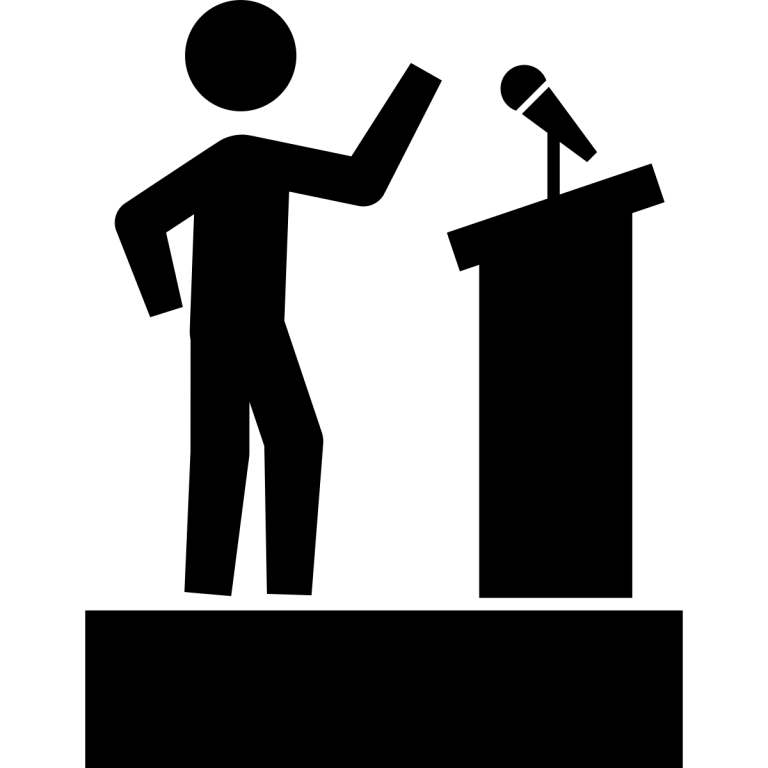 Silhouette of Speaker Giving a Speech at Podium