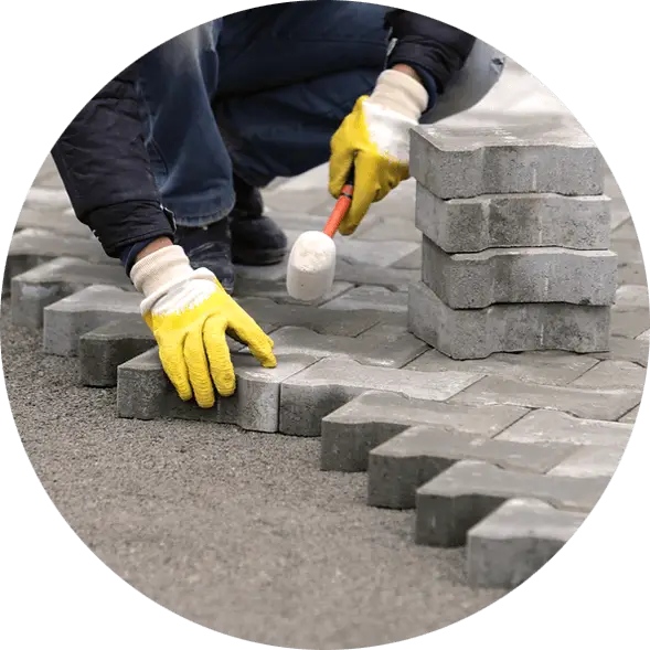 Worker Laying Paving Bricks