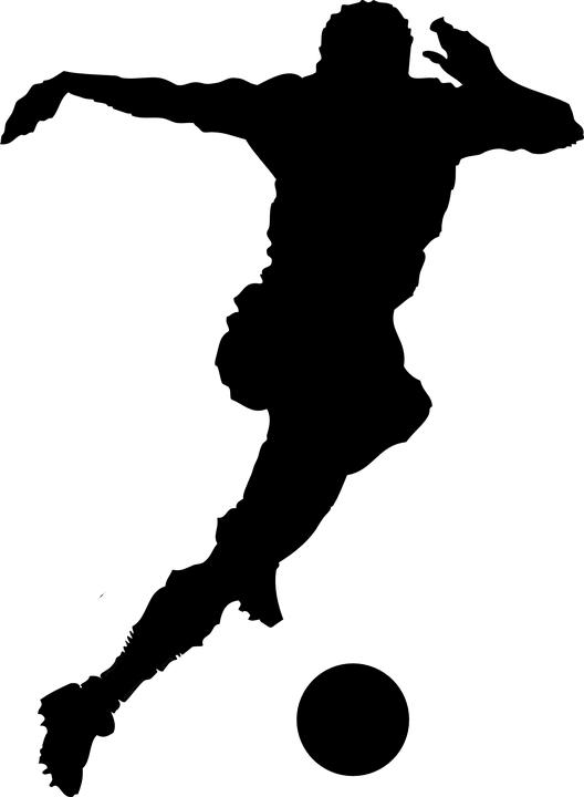 Silhouette of a Soccer Player Kicking a Ball