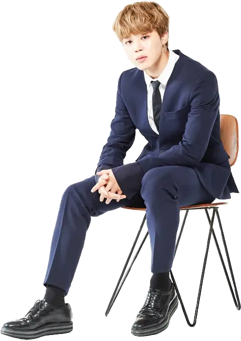 Man in Blue Formal Suit Sitting on Chair