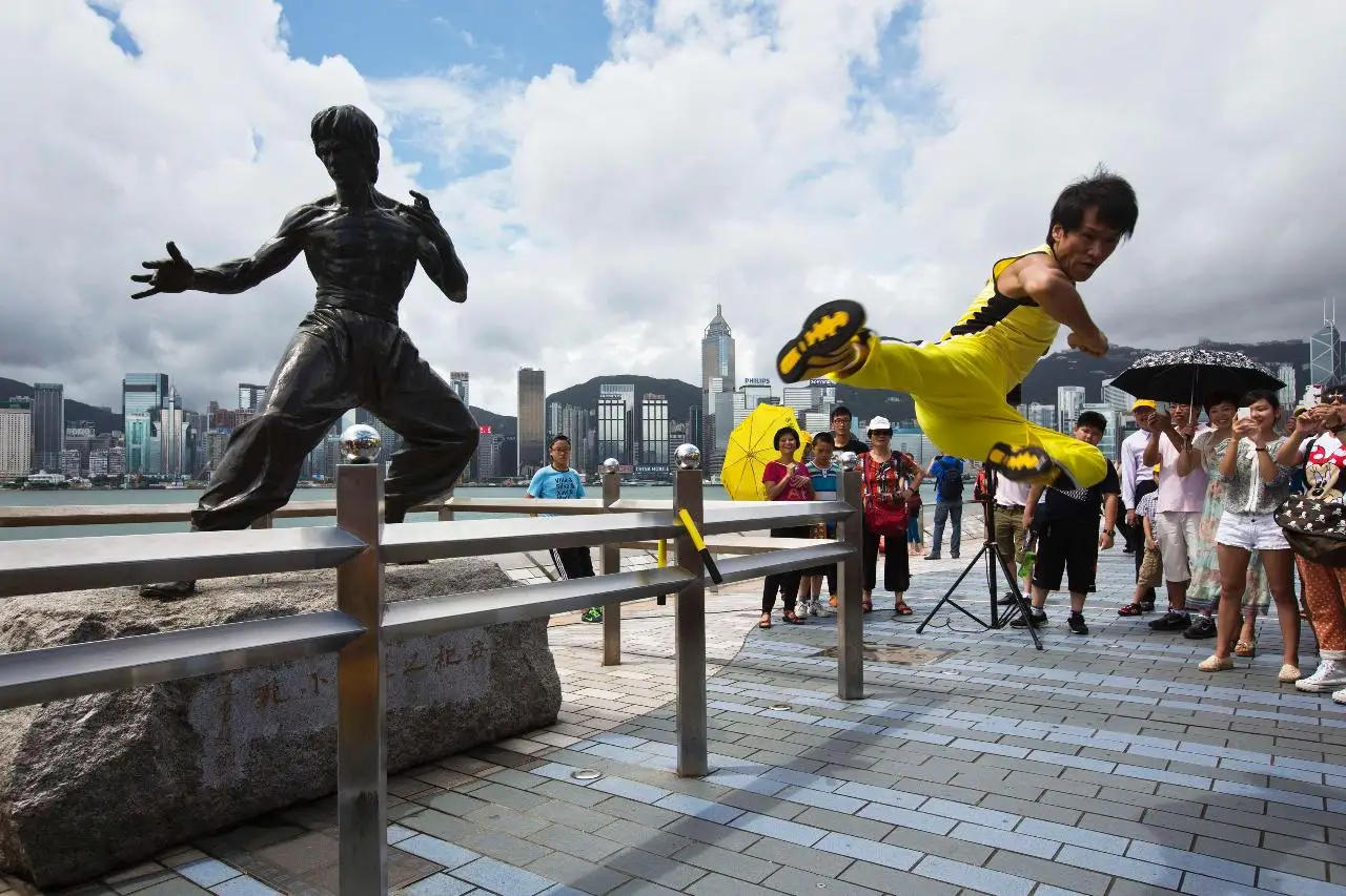 Martial Artist Kicking Near Statue