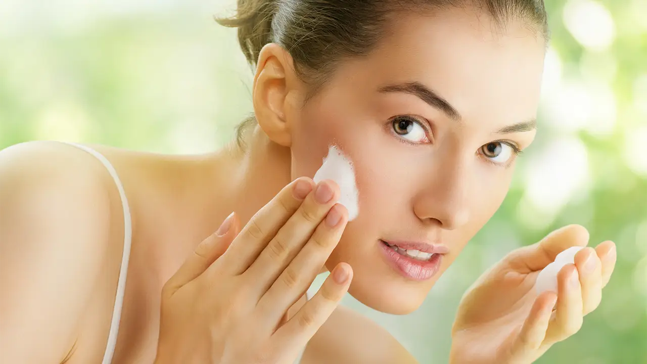Woman Applying Face Cream